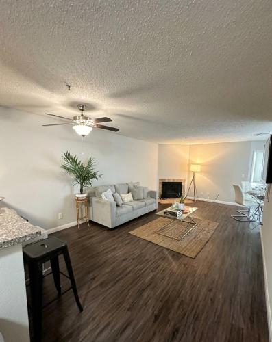 a living room with a couch and a ceiling fan at Modern 2BR Hollywood Apt with Rooftop Pool, Free Parking & Close to Walk of Fame and Universal Studios in Los Angeles