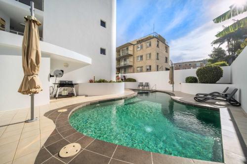 a swimming pool in the middle of a building at Salt & Sky - Stylish Apartment with Pool & Spa in Caloundra