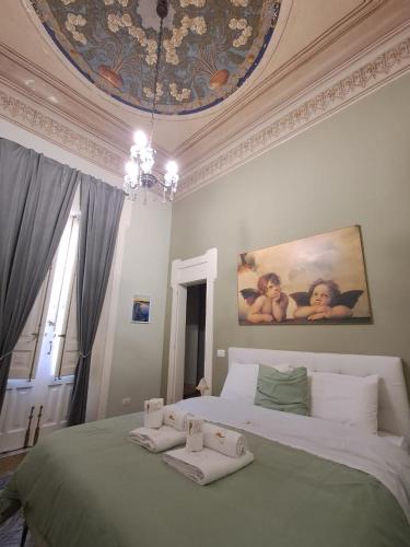 a bedroom with a large bed with towels on it at Affittacamere Stella Rooms in Reggio di Calabria