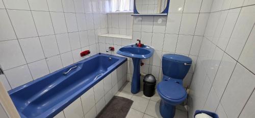 a bathroom with a blue sink and a blue toilet at Seabrook 404 - Sleeps 8 in Margate