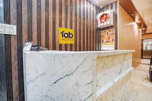 a marble counter in a hotel lobby with a sign at Via Rameshwar Inn in Jhūsi
