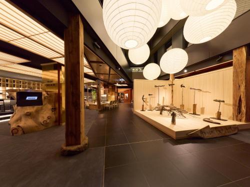 a bathroom with sinks and lights in a building at HOTEL FORK & KNIFE Miyajima in Miyajima