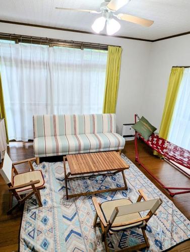 a living room with a couch and two chairs at Satoyama no Yado Kei-House - Vacation STAY 55796v in Shikokuchuo