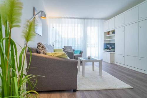 a living room with a couch and a table at Weststrand, App 11 "Seewind" in Westerland
