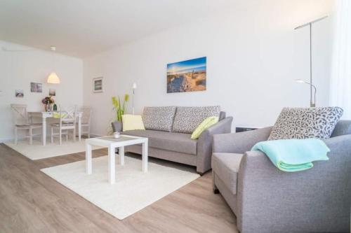a living room with a couch and a table at Weststrand, App 11 "Seewind" in Westerland