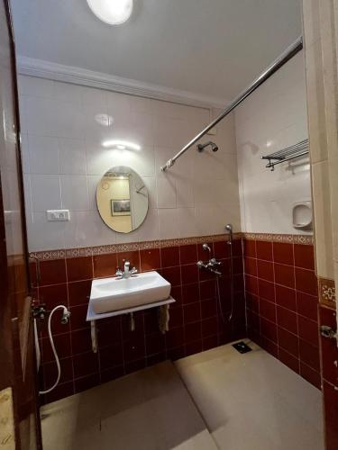 a bathroom with a sink and a mirror at AV apartment beach candolim in Aguada