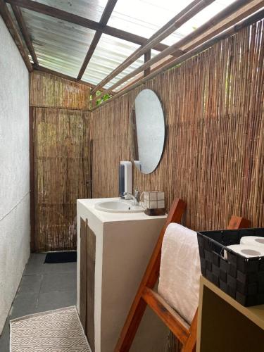 a bathroom with a sink and a mirror at Entire home in General Luna in General Luna