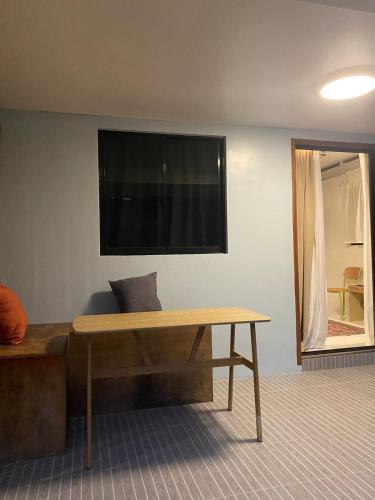 a room with a wooden table and a television on the wall at Entire home in General Luna in General Luna