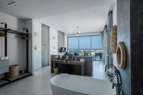 a bathroom with a tub and a desk with a computer at Villa Momo Private Pool near Kata Beach in Kata Beach