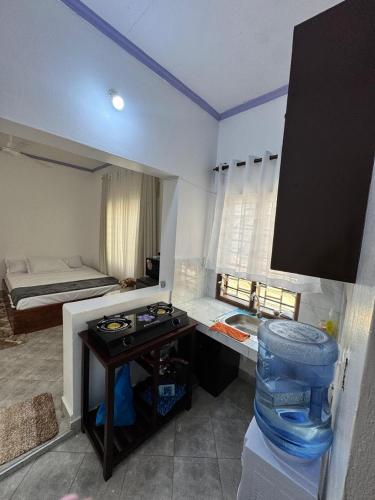 a bathroom with a bed and a sink in a room at nova nest in Watamu