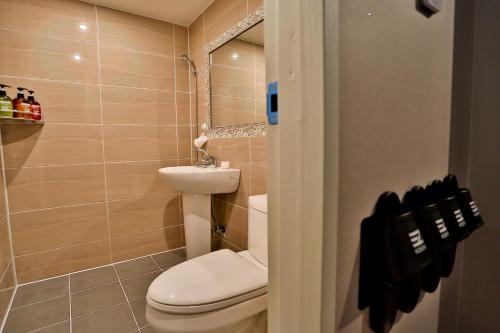 a bathroom with a toilet and a sink at Ezstay-Nampo in Busan