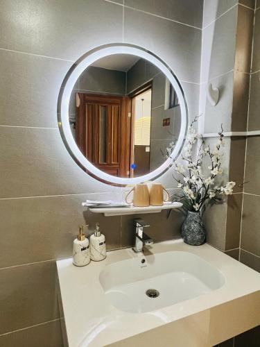 a bathroom with a sink and a mirror at Pony Bliss Haven - Sư Vạn Hạnh in Ho Chi Minh City