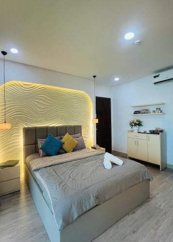 a bedroom with a large bed with colorful pillows at Pony Bliss Haven - Sư Vạn Hạnh in Ho Chi Minh City