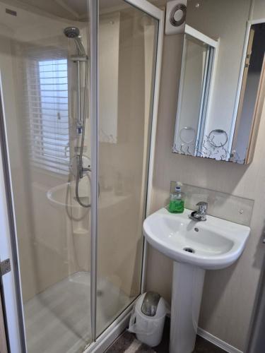 a bathroom with a sink and a shower at Bude Caravan Caromax - Families and Couples Only in Bude