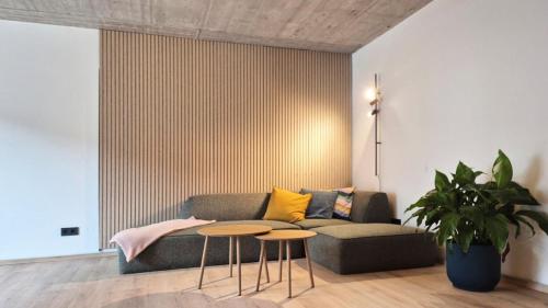a living room with a couch and two tables at Haus am FELS Steinbrech in Hermagor