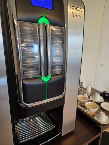 a refrigerator with books on it in a kitchen at Santat Central hôtel in Bellac