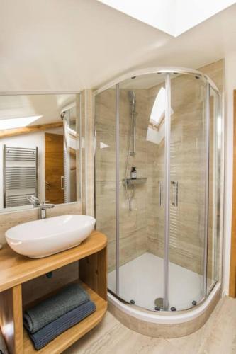 a bathroom with a sink and a shower at Apartma Luna with mountain view in Kobarid