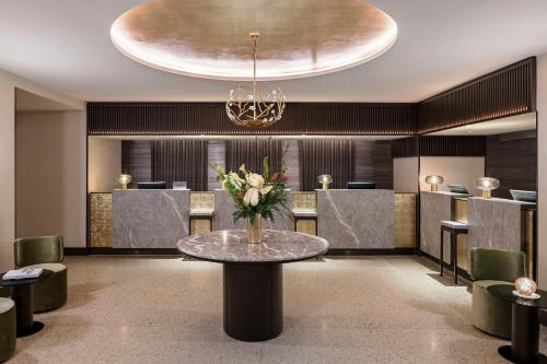 a lobby with a table with flowers on it at Rosa Grand Milano - Starhotels Collezione in Milan