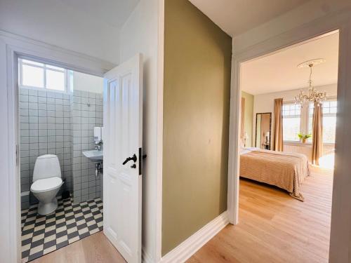 a bathroom with a toilet and a sink in a room at aday - Aalborg Mansion - 3 bedroom apartment in Aalborg