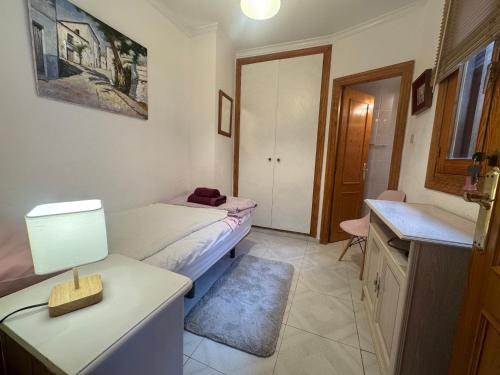 a bedroom with a bed and a table with a lamp at Tara Casa in Cartagena