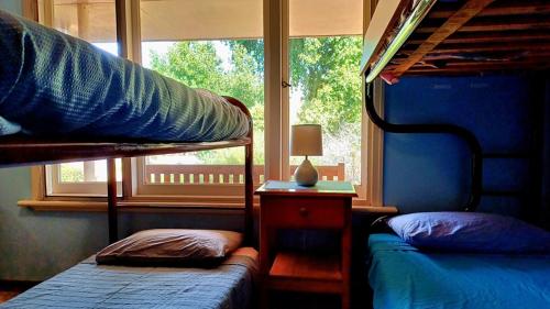 a bedroom with two bunk beds and a window at Warradale Lodge and Mini Golf in Palgarup