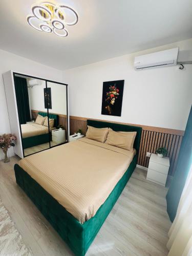 a bedroom with a large bed and a mirror at RxM HOME CITY in Chiajna