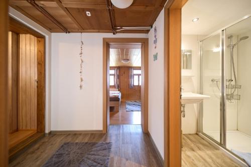 a hallway with a bathroom with a shower and a sink at Landhaus-Willi in Gaschurn