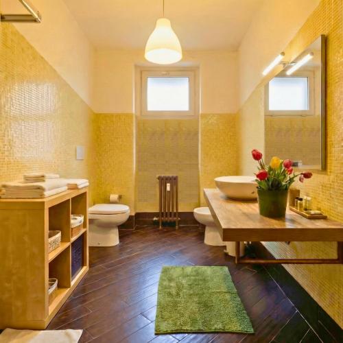 a bathroom with a sink and a toilet and a tub at Melo Accommodations in Bari