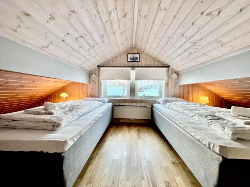 a large room with two beds in it at Nordic Elegance Retreat in Sørvågen