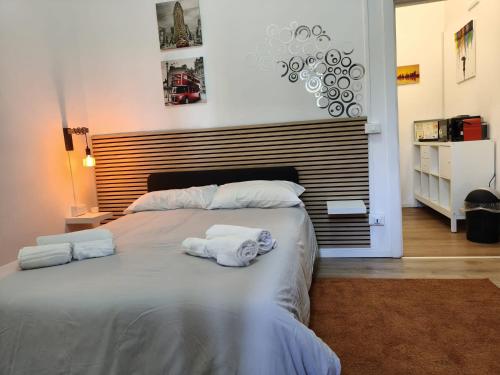 a bedroom with a large bed with towels on it at U Casteddu - Case Vacanza Aci Castello in Aci Castello