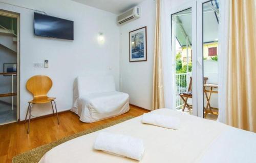 a hotel room with two beds and a balcony at Villa Katina Supetar with private pool, pool table, barbecue in Supetar