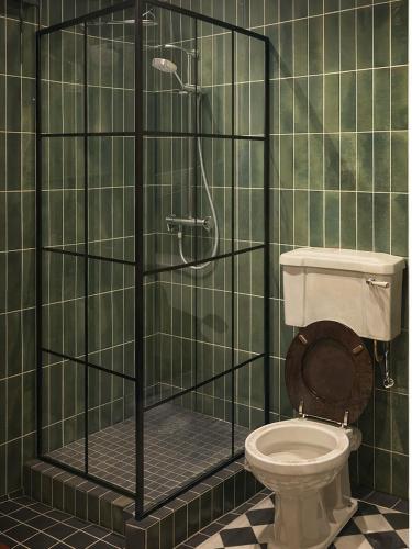 a bathroom with a toilet and a glass shower at The Scarlet Bath in Bath