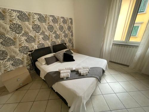 a bedroom with a bed with two towels on it at Jacuzzi Suite in Livorno