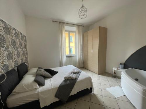 a bedroom with a bed and a tub and a sink at Jacuzzi Suite in Livorno