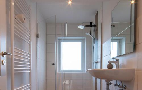 a bathroom with a sink and a shower with a window at Wolke 7 – PEAK Andreasberg in Sankt Andreasberg