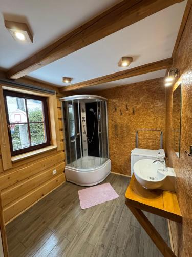 a bathroom with a large tub and a sink at Chalupa Nella in Velké Karlovice
