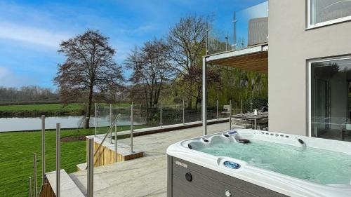 a jacuzzi tub in the backyard of a house at The Nait in Fladbury