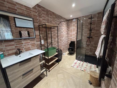 a bathroom with a shower and a sink and a glass shower at Loft dans les vignes in La Cadière-dʼAzur