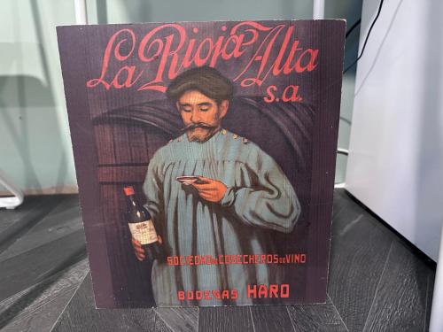 a book with a picture of a man holding a bottle of wine at Cozy cabin independent ensuite in Guildford