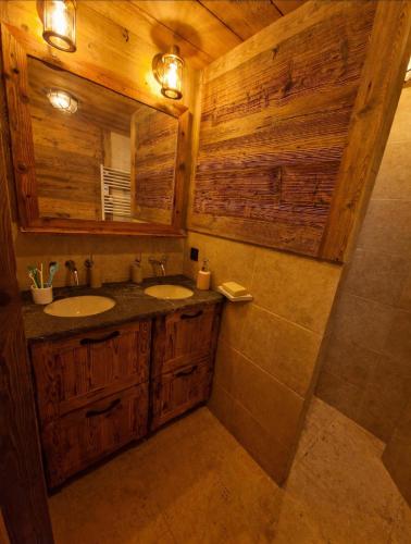 a bathroom with two sinks and a mirror at Les Chryolles - Les Marmottes in Valmeinier