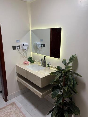 a bathroom with a sink and a mirror at ترف in Medina