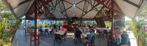 a rendering of a restaurant with people sitting at tables at Hosanna village in Semporna