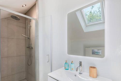 a white bathroom with a sink and a shower at Greenwood House in Whitegate