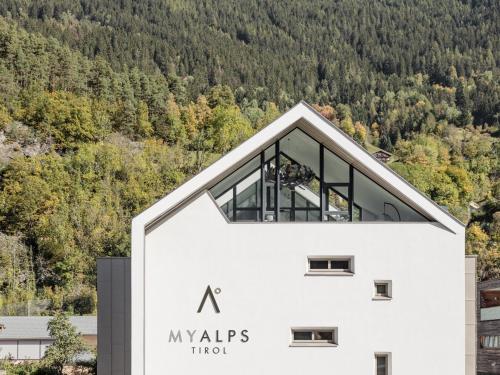 a large white building with the letter a on it at MYALPS Tirol inklusive Sky- Wellness in Oetz