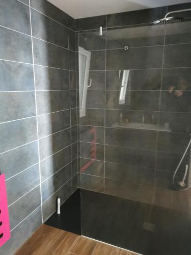 a bathroom with a shower with gray tiles at La Belle Vue Piscine chauffée et abritée, vue sur l'océan, plage à pied, bord de mer, BRETAGNE LBC in Clohars-Carnoët