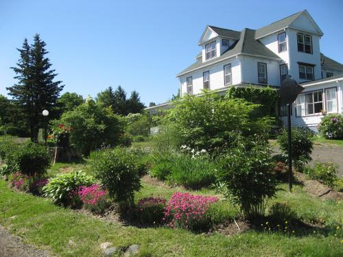 a house with a garden of flowers in front of it at Harbourview Inn in Smiths Cove