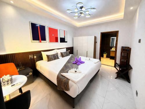 a bedroom with a large white bed and a sink at Samma Karuna Beach & Wellness Resort - Intoxicants free in Srithanu