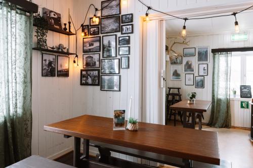 a room with a table and pictures on the wall at Gjestehuset 102 - your home away from home! in Longyearbyen