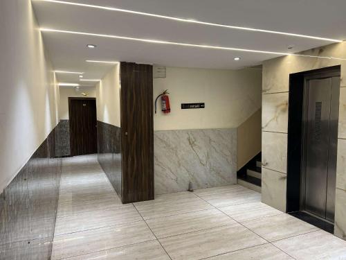 a lobby with a staircase and a fire extinguisher at Hotel SHREE PALACE in Ratlām