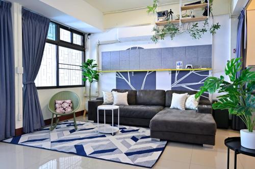 a living room with a couch and a rug at Blue Theatre Near Nimmanhaemin Road and Old City in Chiang Mai